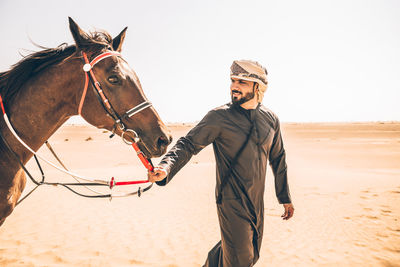 Full length of a horse on sand