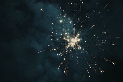 Low angle view of firework display at night