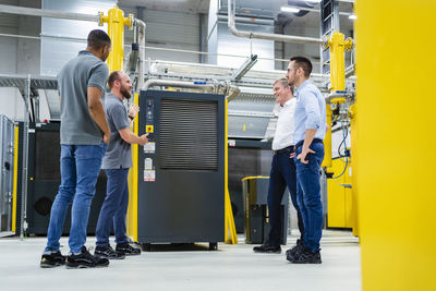 Businessmen and employees having a meeting in factory