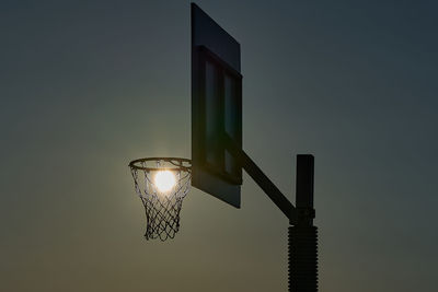 Low angle view of illuminated street light against sky