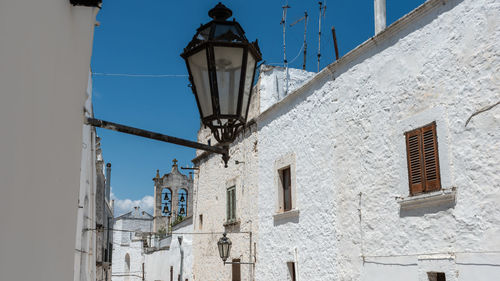 Low angle view of street light against building