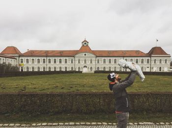 Man photographing against sky