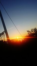 Silhouette landscape against sky during sunset