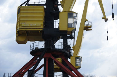 Low angle view of crane against sky