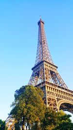 Sunny morning shot of eiffel tower with blue sky in background