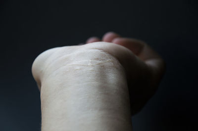 Close-up of human hand against white background