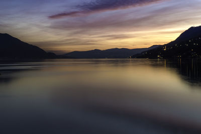 Scenic view of lake against sky at sunset