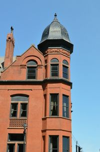 Low angle view of building against clear blue sky