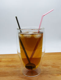 Close-up of drink on table against white background