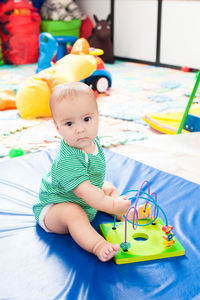 Cute boy playing with toy at home