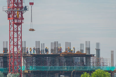 People standing by cityscape against sky