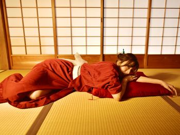 Young woman lying on floor at home