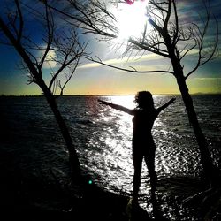 Silhouette of woman standing on beach