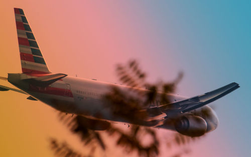 Close-up of airplane flying against clear sky