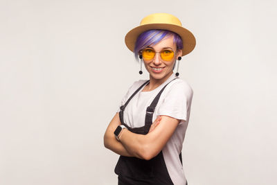 Portrait of smiling young woman against white background