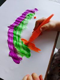 Cropped image of woman holding multi colored bouquet