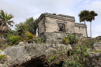 Low angle view of old building against cloudy sky