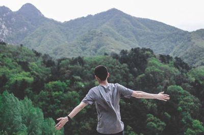 Rear view of man looking at mountains