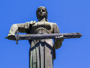 Low angle view of statue against clear blue sky