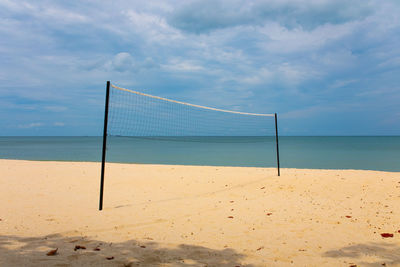 Scenic view of beach with volleyball net against sky