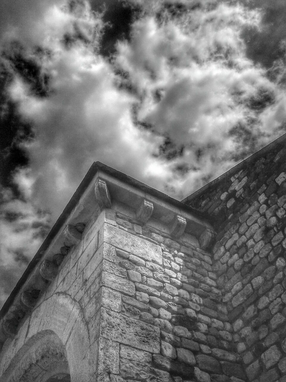 architecture, built structure, building exterior, low angle view, sky, cloud - sky, cloudy, brick wall, old, building, cloud, stone wall, day, abandoned, wall - building feature, no people, outdoors, window, damaged, history