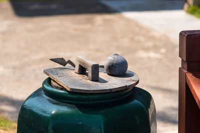 Close-up of metal container on wood