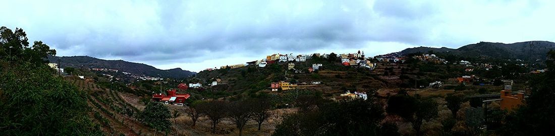 Scenic view of mountains against cloudy sky