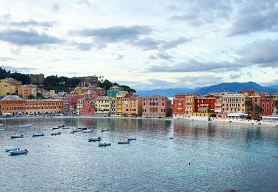 Scenic view of sea by city against sky