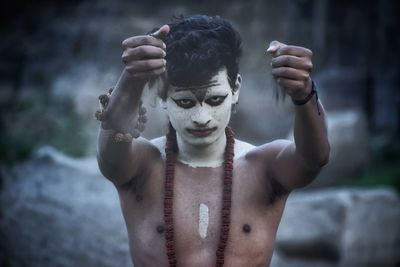 Portrait of young man standing outdoors