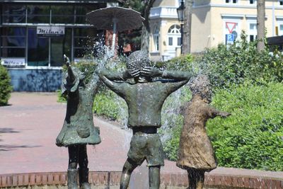 Statue by water in city