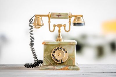 Close-up of telephone booth on table