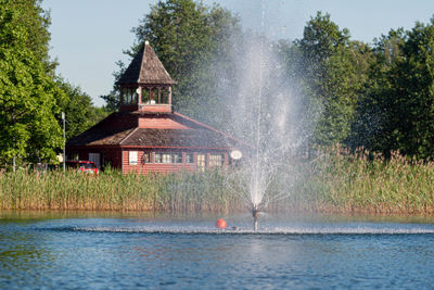 House by lake against building