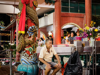 Statue of people in front of building