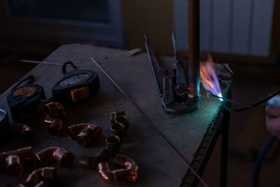 A worker welds copper pipes with a gas torch for central heating