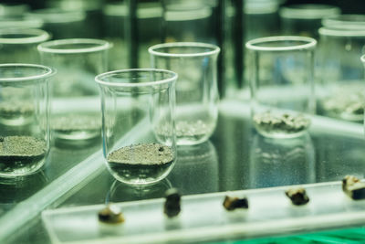 Minerals in laboratory glassware on table