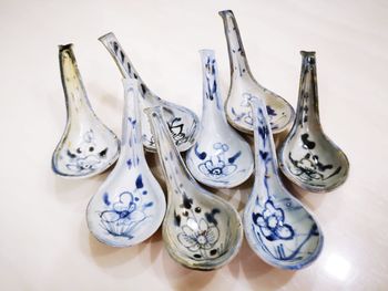 High angle view of patterned spoons on table