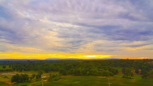 Scenic view of field against sky during sunset