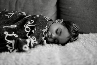 Cute boy sleeping on bed