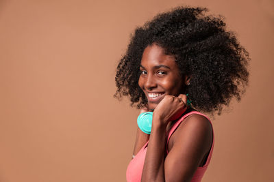 Portrait of a smiling young woman against gray background