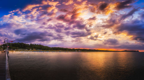 Scenic view of lake against romantic sky at sunset