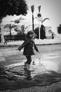 Girl playing in puddle