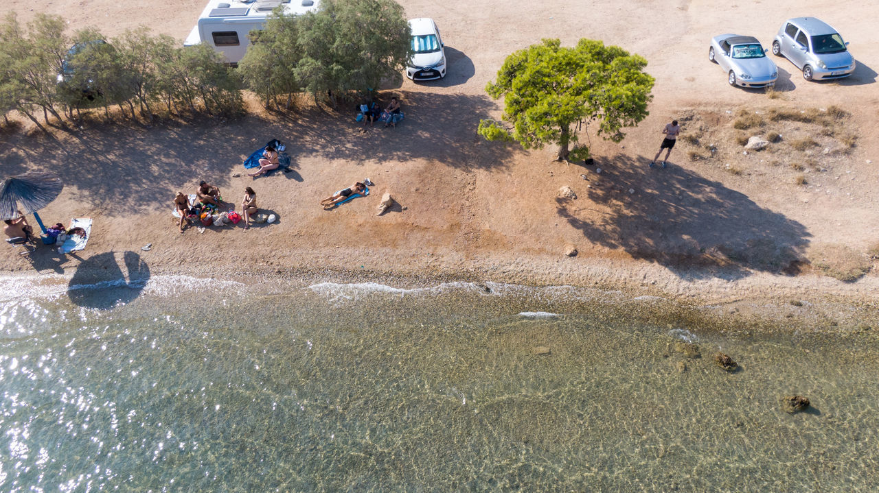 HIGH ANGLE VIEW OF PEOPLE ENJOYING AT BEACH