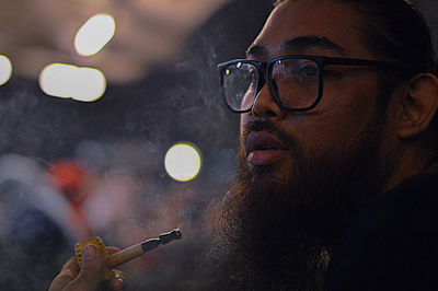 Close-up of man looking away while smoking