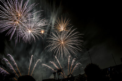 Low angle view of firework display at night