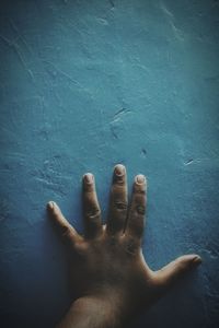 Cropped image of hand on wall