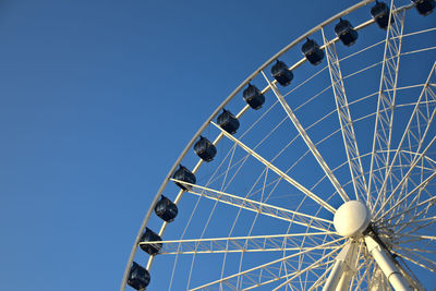 Low angle view of ferris wheel against clear sky