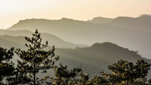 Scenic view of silhouette mountains against sky at sunset