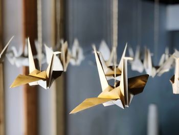 Close-up of hanging origami birds