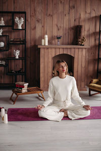 Full length of woman sitting on table