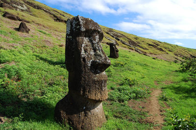 Stone sculptures on grassy field